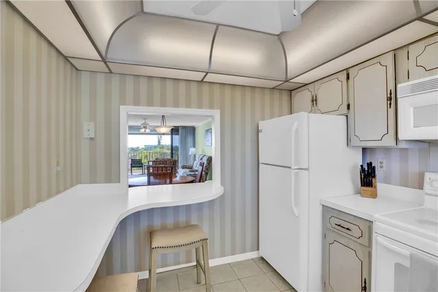 a kitchen with refrigerator a sink and cabinets