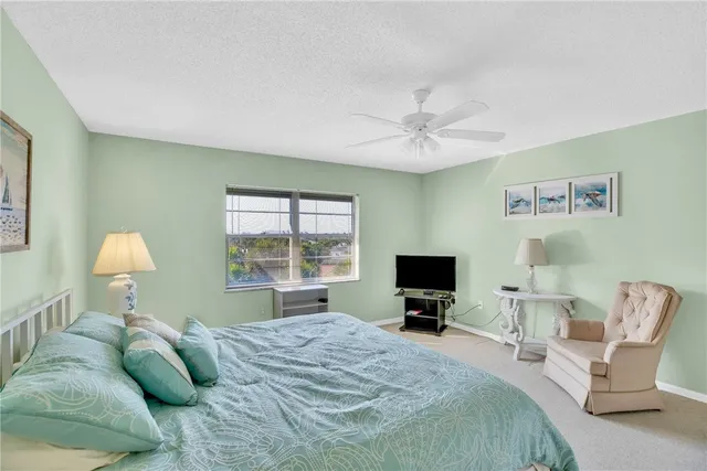 a bedroom with a bed and a tv