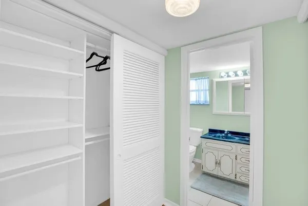 a walk in closet and a window