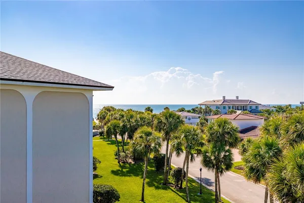 a blue swimming pool with a garden in the back
