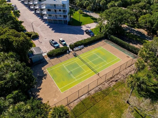 an aerial view of a tennis ground and large trees