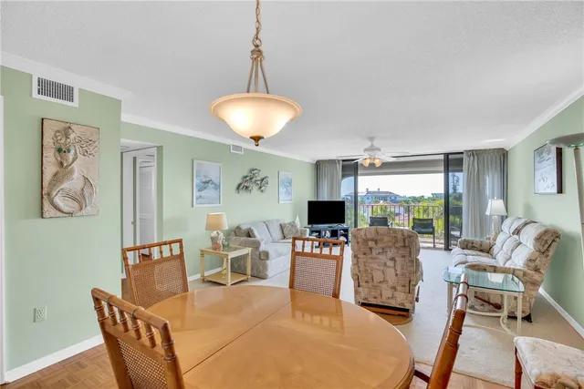a living room with furniture a flat screen tv and a large window