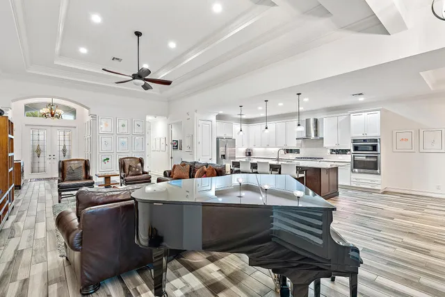 a kitchen with stainless steel appliances granite countertop a stove top oven a sink island and a refrigerator