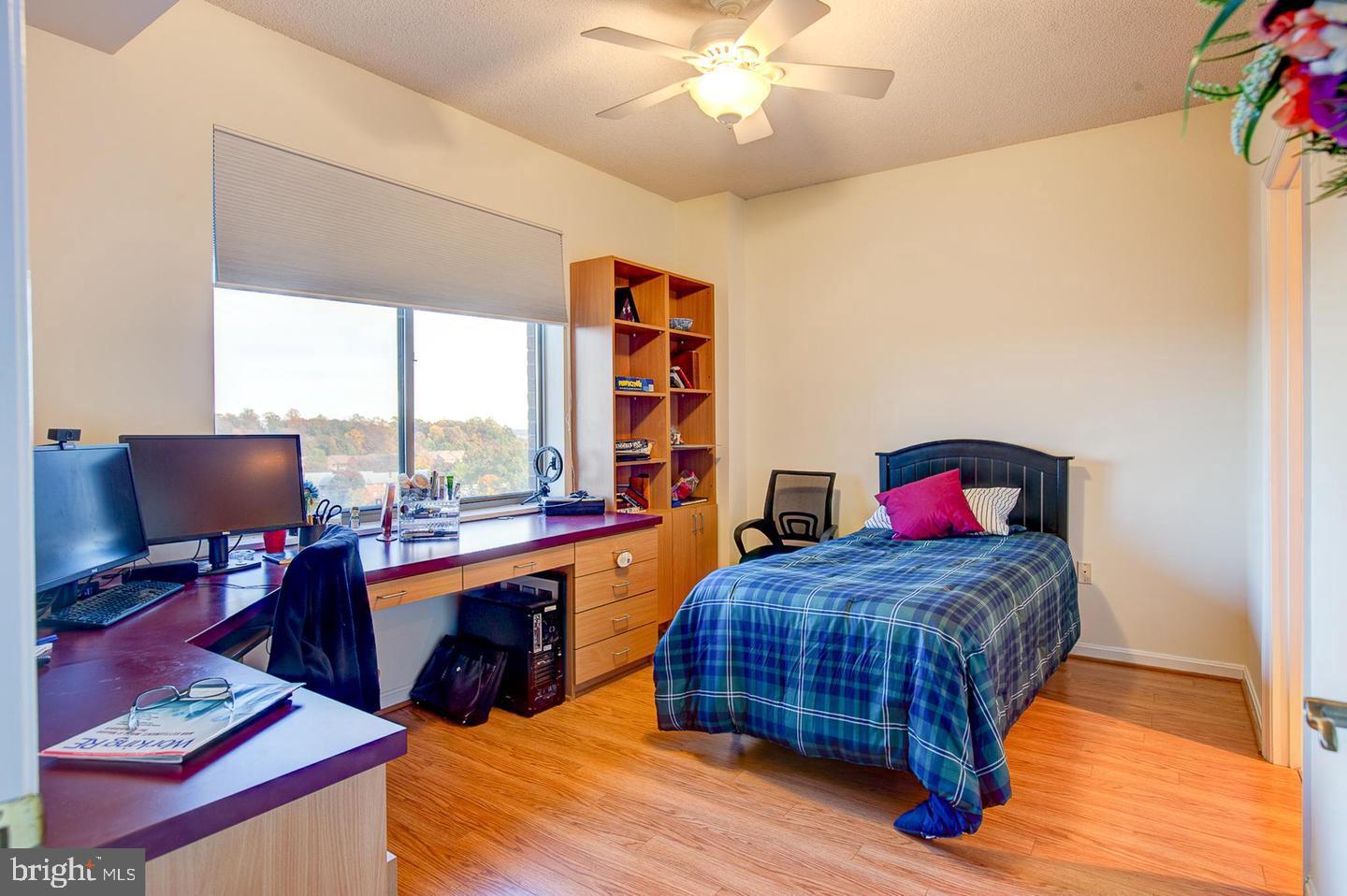 3200 North Leisure World Boulevard, Unit 911 Silver Spring, MD 20906 - Photo 12 of 39 a bedroom with a bed and a desk