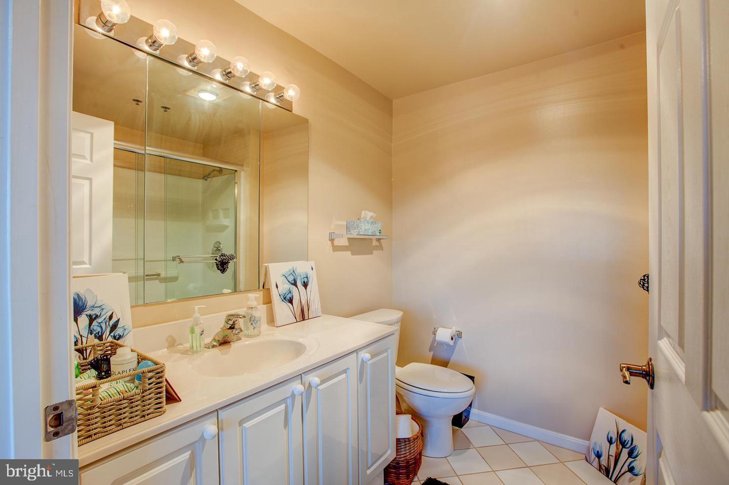 3200 North Leisure World Boulevard, Unit 911 Silver Spring, MD 20906 - Photo 13 of 39 a bathroom with a sink toilet vanity and shower