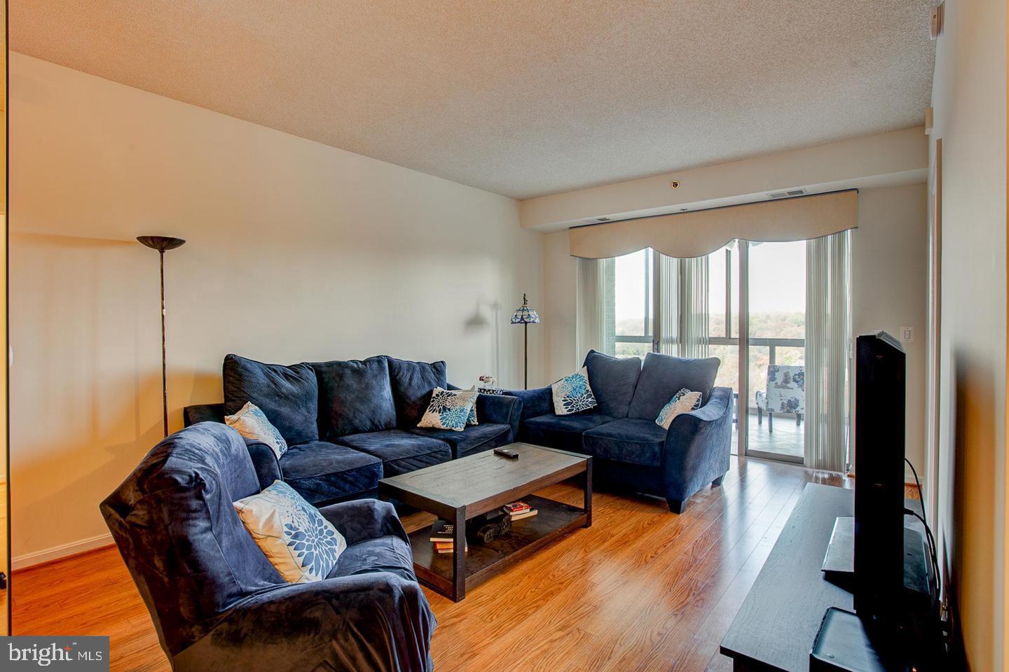 3200 North Leisure World Boulevard, Unit 911 Silver Spring, MD 20906 - Photo 5 of 39 a living room with furniture and a large window
