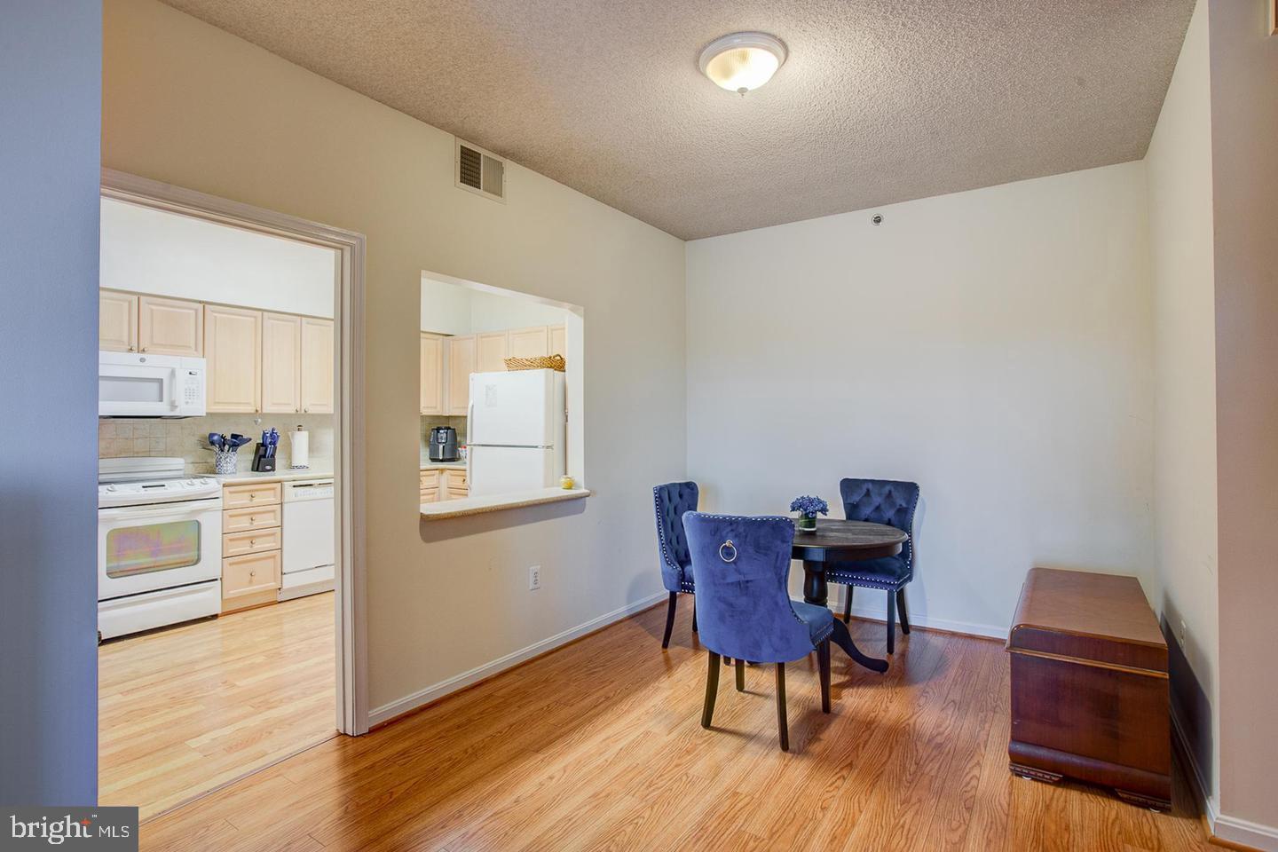 3200 North Leisure World Boulevard, Unit 911 Silver Spring, MD 20906 - Photo 6 of 39 a view of a dining room with furniture and wooden floor