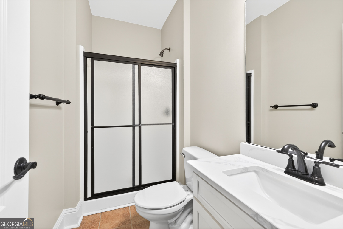 1121 Deer Trail Bishop, GA 30621 - Photo 38 of 98 a bathroom with a toilet a sink and a mirror