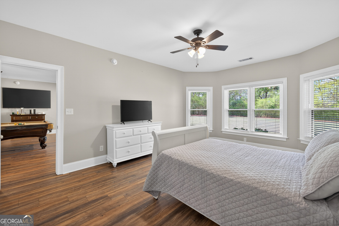 1121 Deer Trail Bishop, GA 30621 - Photo 49 of 98 a bedroom with a bed and a flat screen tv