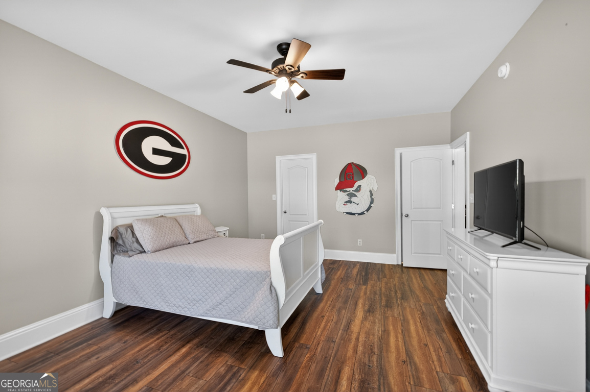 1121 Deer Trail Bishop, GA 30621 - Photo 50 of 98 a bedroom with a bed and a flat screen tv