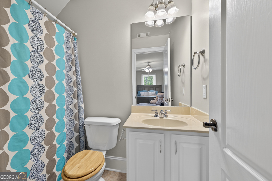 1121 Deer Trail Bishop, GA 30621 - Photo 55 of 98 a bathroom with a toilet a sink and a mirror