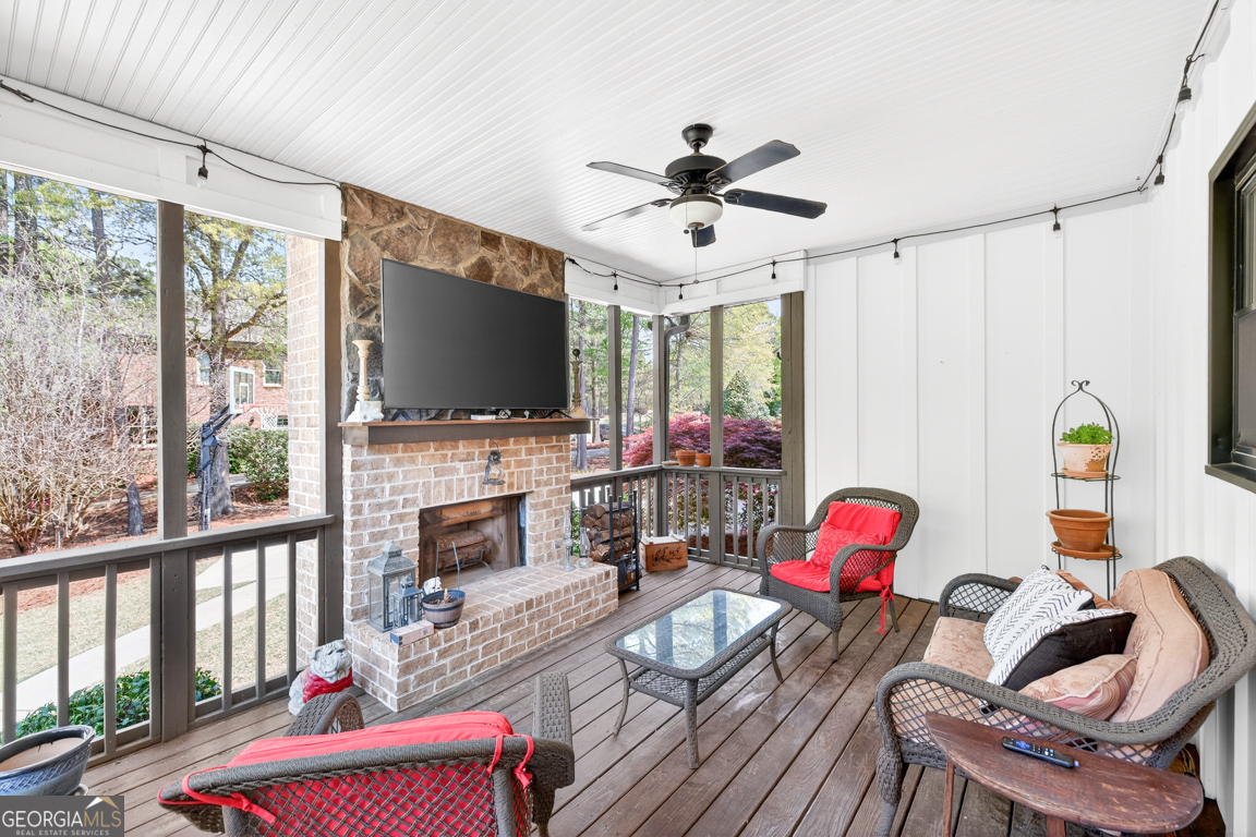 1121 Deer Trail Bishop, GA 30621 - Photo 58 of 98 a living room with furniture a flat screen tv and a floor to ceiling window