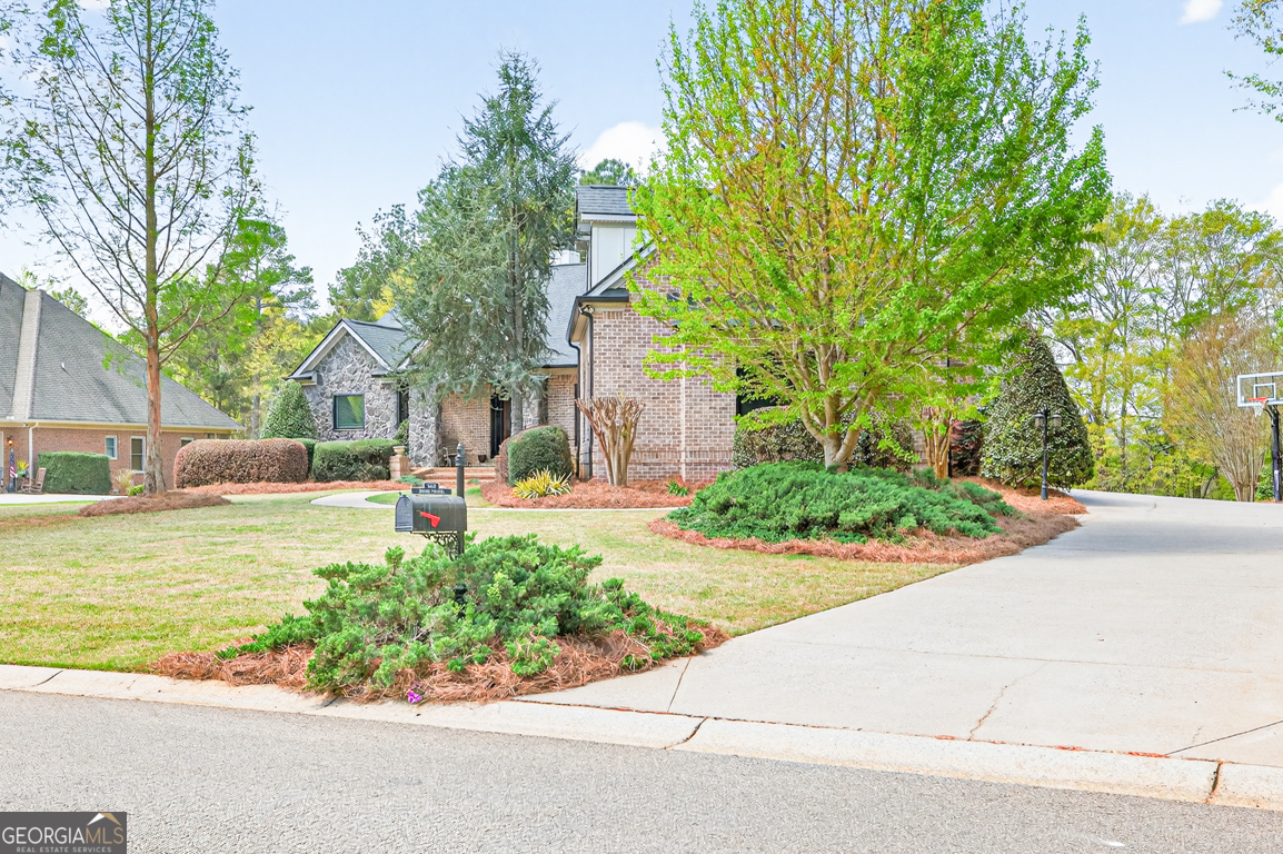 1121 Deer Trail Bishop, GA 30621 - Photo 6 of 98 a front view of a house with garden and trees