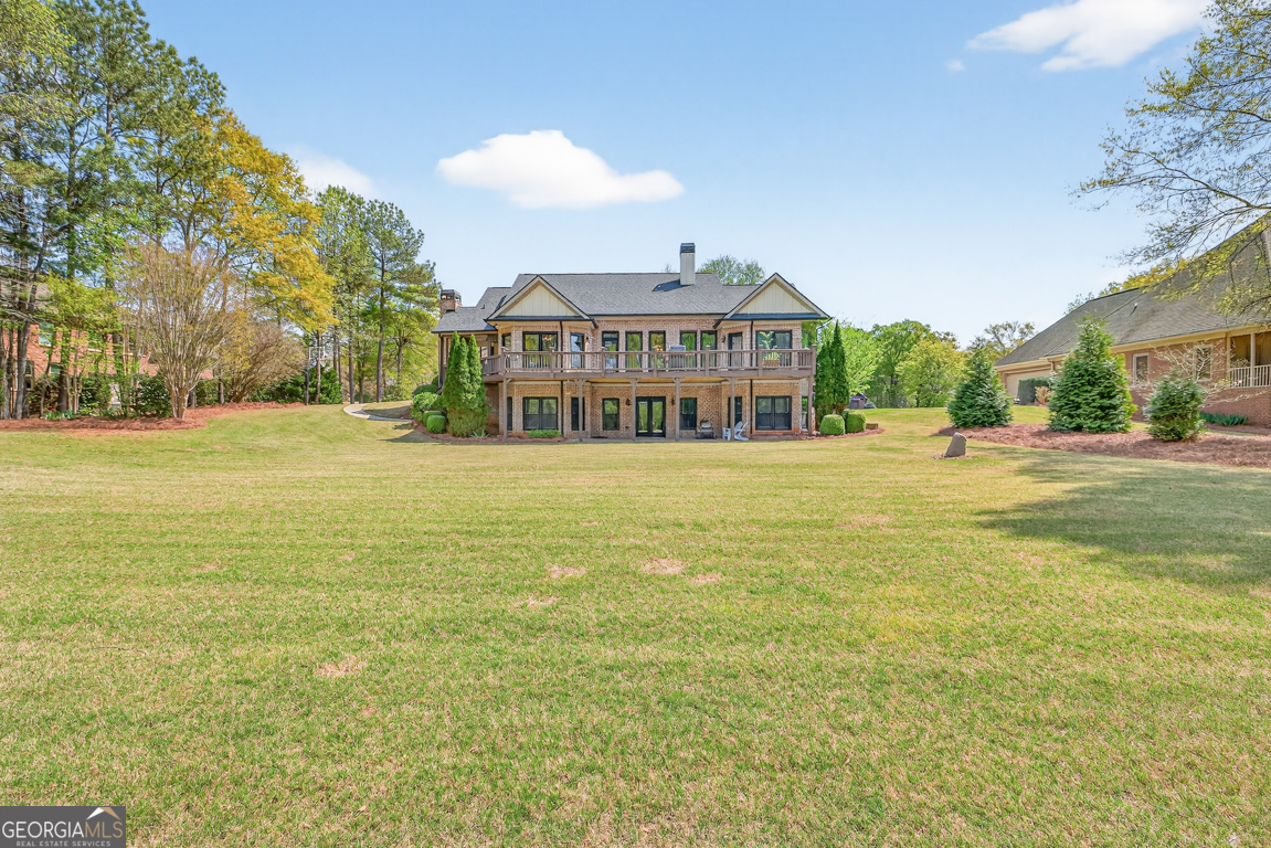 1121 Deer Trail Bishop, GA 30621 - Photo 66 of 98 a view of a big room with a big yard and large trees
