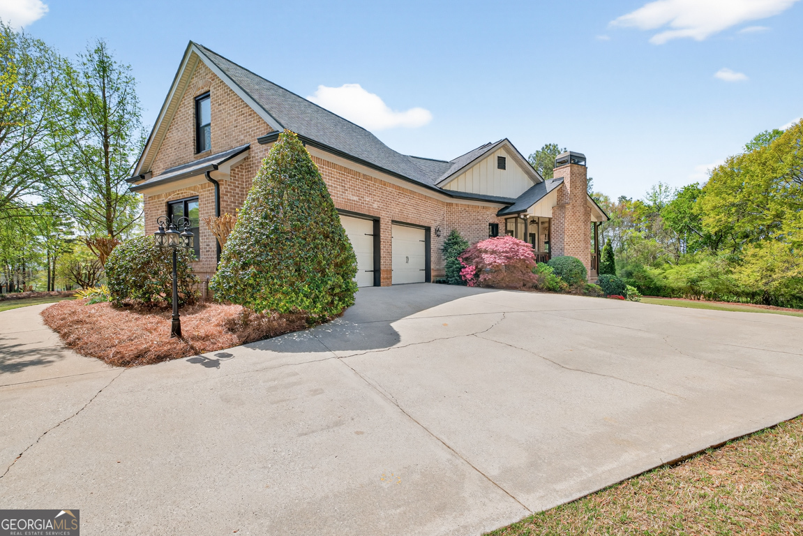 1121 Deer Trail Bishop, GA 30621 - Photo 8 of 98 a front view of a house with a yard and garage