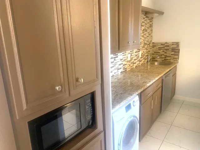 a view of open kitchen cabinets and window