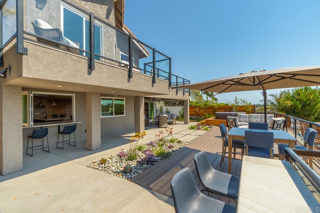 1784 Hawk View Drive Encinitas, CA 92024 - Photo 21 of 71 a view of a patio with couches table and chairs under an umbrella