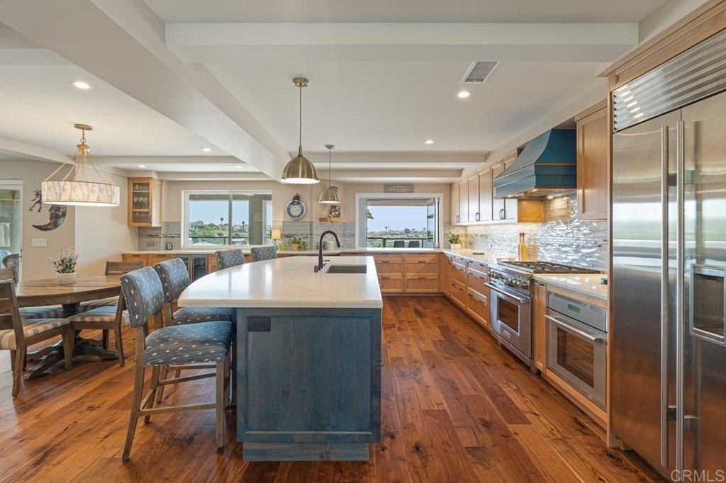 1784 Hawk View Drive Encinitas, CA 92024 - Photo 32 of 71 a kitchen with stainless steel appliances granite countertop a lot of cabinets and wooden floor