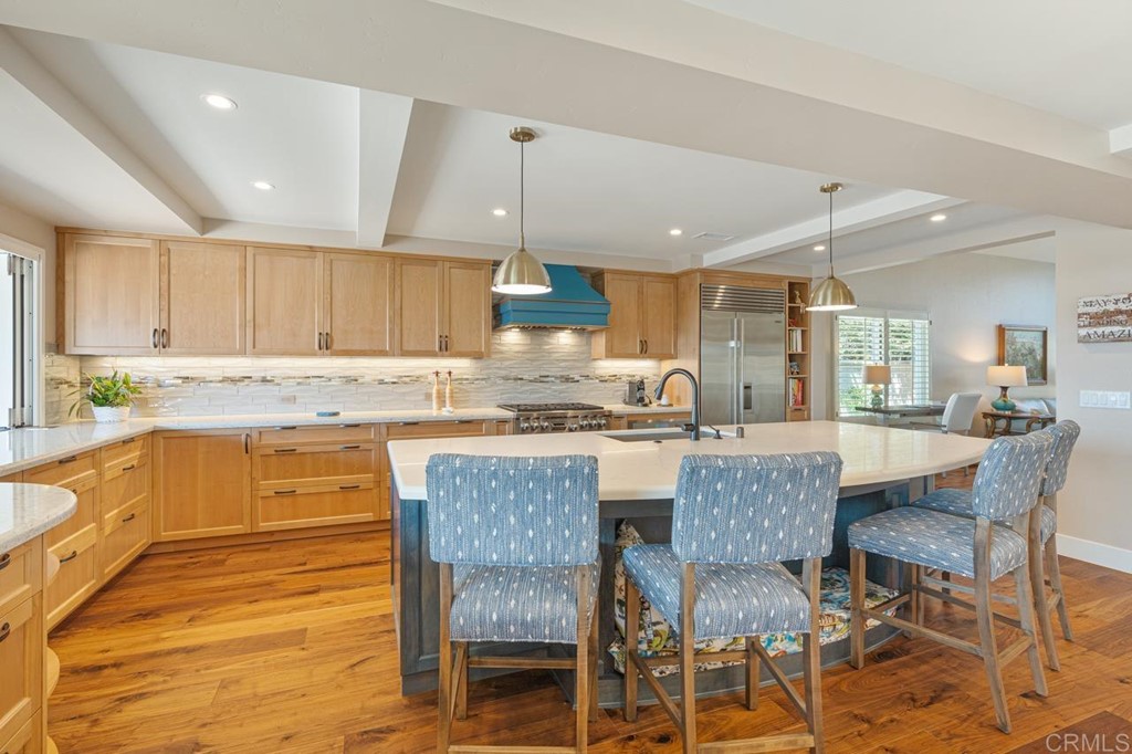1784 Hawk View Drive Encinitas, CA 92024 - Photo 33 of 71 a kitchen with granite countertop a table chairs microwave and cabinets