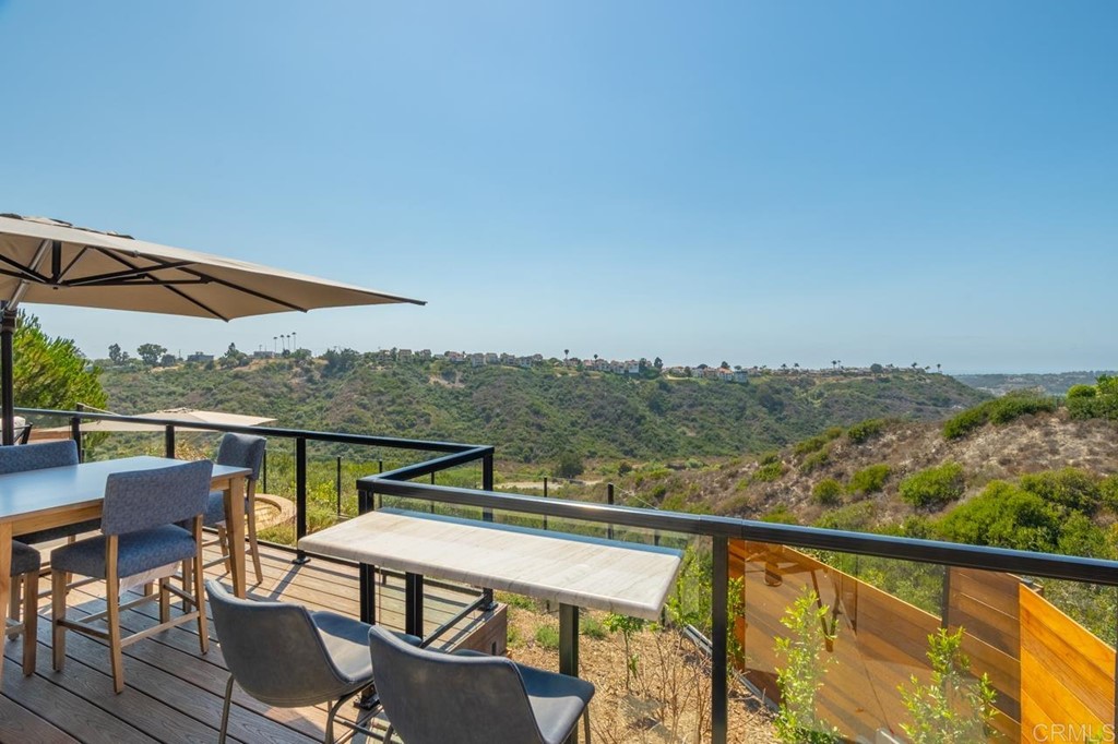 1784 Hawk View Drive Encinitas, CA 92024 - Photo 49 of 71 a view of a balcony with chairs and wooden floor