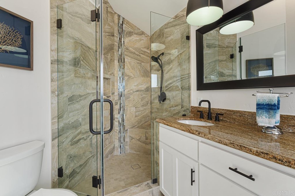1784 Hawk View Drive Encinitas, CA 92024 - Photo 58 of 71 a bathroom with a granite countertop sink a mirror and shower