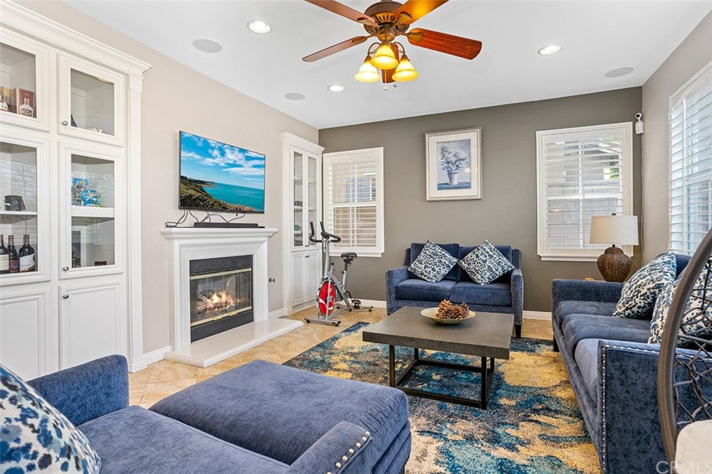 12547 Vintner Drive Rancho Cucamonga, CA 91739 - Photo 12 of 52 a living room with furniture a flat screen tv and a fireplace