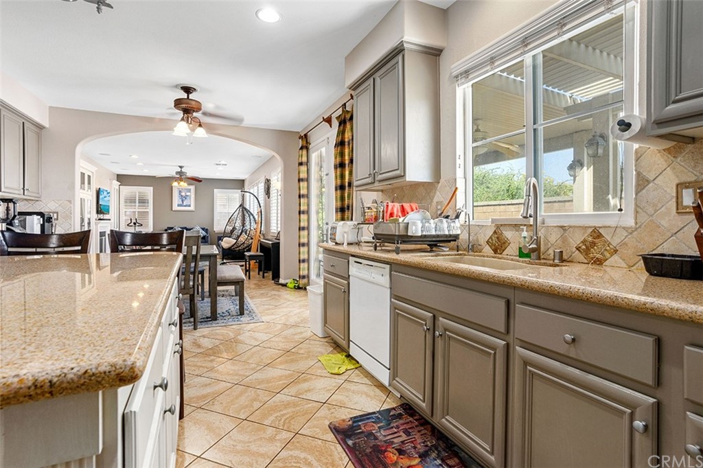 12547 Vintner Drive Rancho Cucamonga, CA 91739 - Photo 21 of 52 a very nice looking open kitchen with granite countertop a sink and a large window