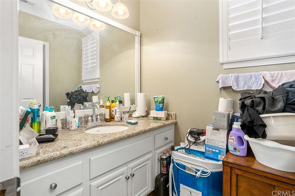 12547 Vintner Drive Rancho Cucamonga, CA 91739 - Photo 27 of 52 a bathroom with a sink and a mirror