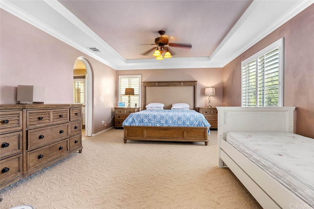 12547 Vintner Drive Rancho Cucamonga, CA 91739 - Photo 28 of 52 a bedroom with a bed and a chandelier
