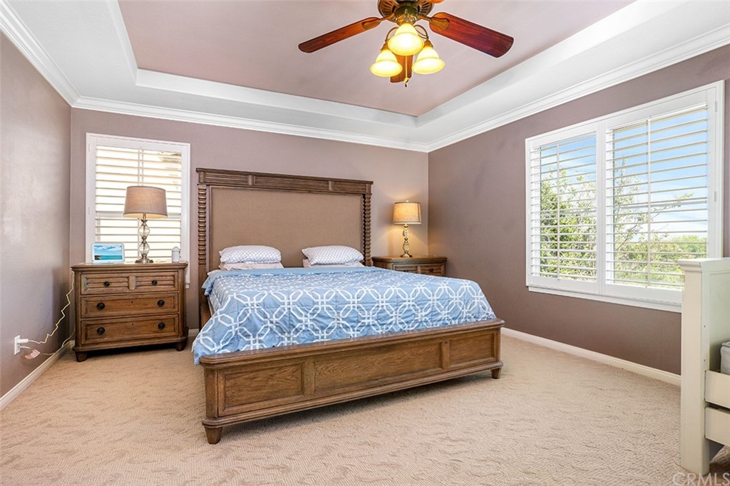 12547 Vintner Drive Rancho Cucamonga, CA 91739 - Photo 29 of 52 a bedroom with a bed and a chandelier