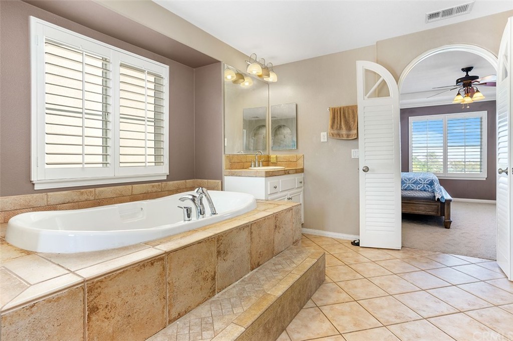 12547 Vintner Drive Rancho Cucamonga, CA 91739 - Photo 33 of 52 a spacious bathroom with a tub a double vanity sink and mirror