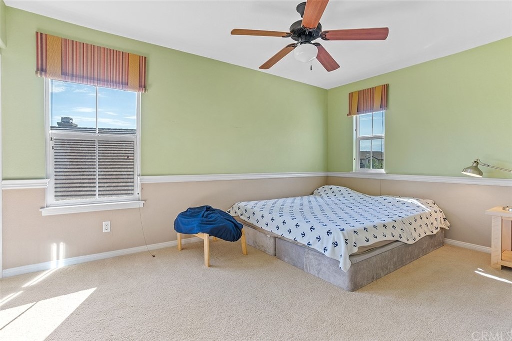 12547 Vintner Drive Rancho Cucamonga, CA 91739 - Photo 41 of 52 a bedroom with a bed a chandelier and a window