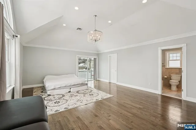 a bedroom with furniture and wooden floor