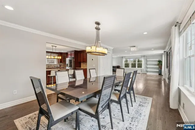 a dining room with furniture window and wooden floor