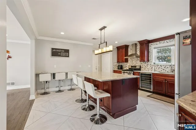 a kitchen with granite countertop a stove a table and chairs in it
