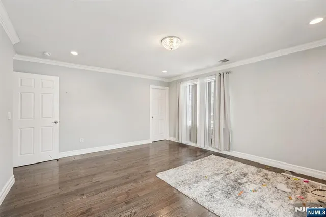 an empty room with wooden floor