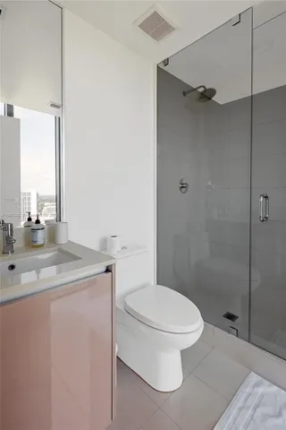 a bedroom with a bed and glass window