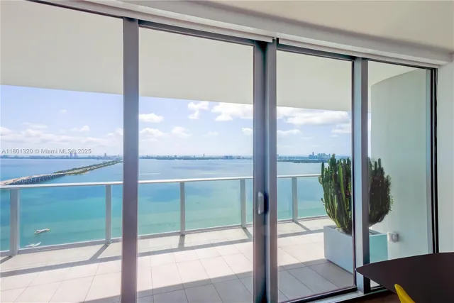 a view of a glass door and the balcony