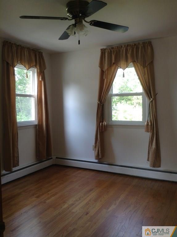 25 Cambridge Road Edison, NJ 08817 - Photo 3 of 13 an empty room with wooden floor and windows