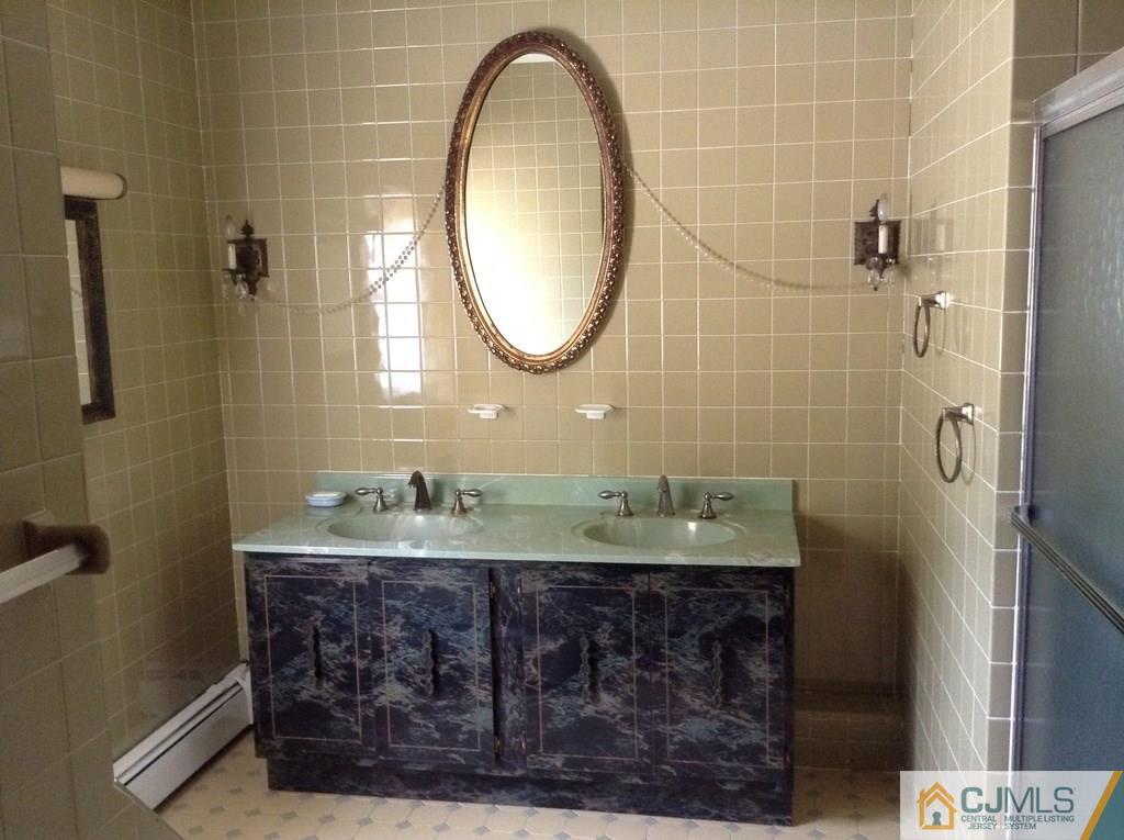 25 Cambridge Road Edison, NJ 08817 - Photo 4 of 13 a bathroom with a sink and a mirror