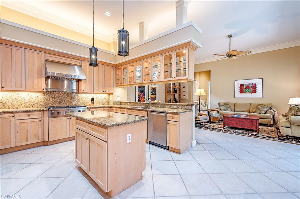 7084 Verde Way Naples, FL 34108 - Photo 11 of 18 a kitchen with stainless steel appliances granite countertop a stove a sink and a refrigerator