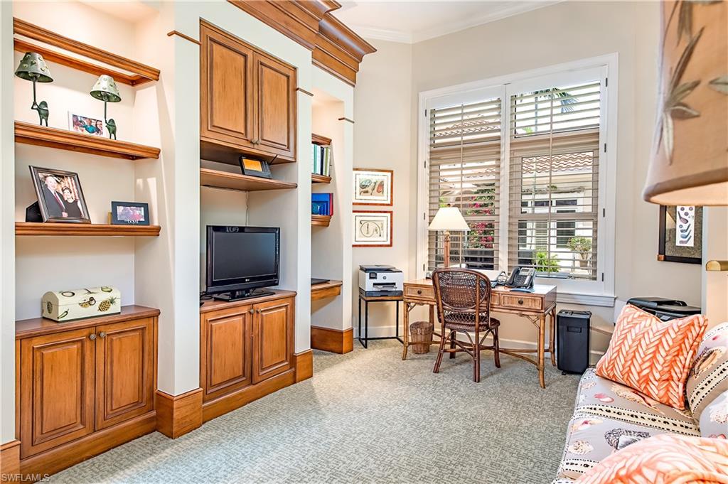7084 Verde Way Naples, FL 34108 - Photo 13 of 18 a living room with furniture a flat screen tv and large window