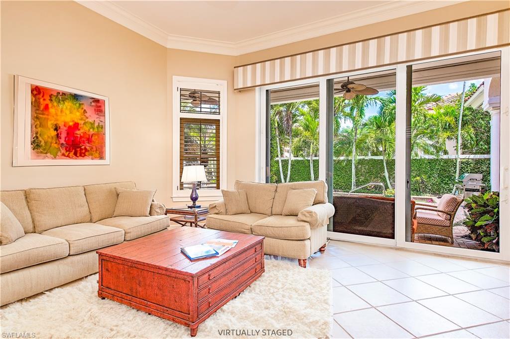 7084 Verde Way Naples, FL 34108 - Photo 14 of 18 a living room with furniture and a large window