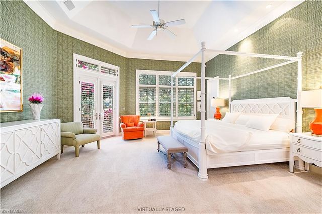 a bedroom with furniture and a large window