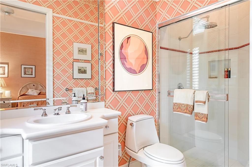 7084 Verde Way Naples, FL 34108 - Photo 18 of 18 a bathroom with a sink a toilet and shower