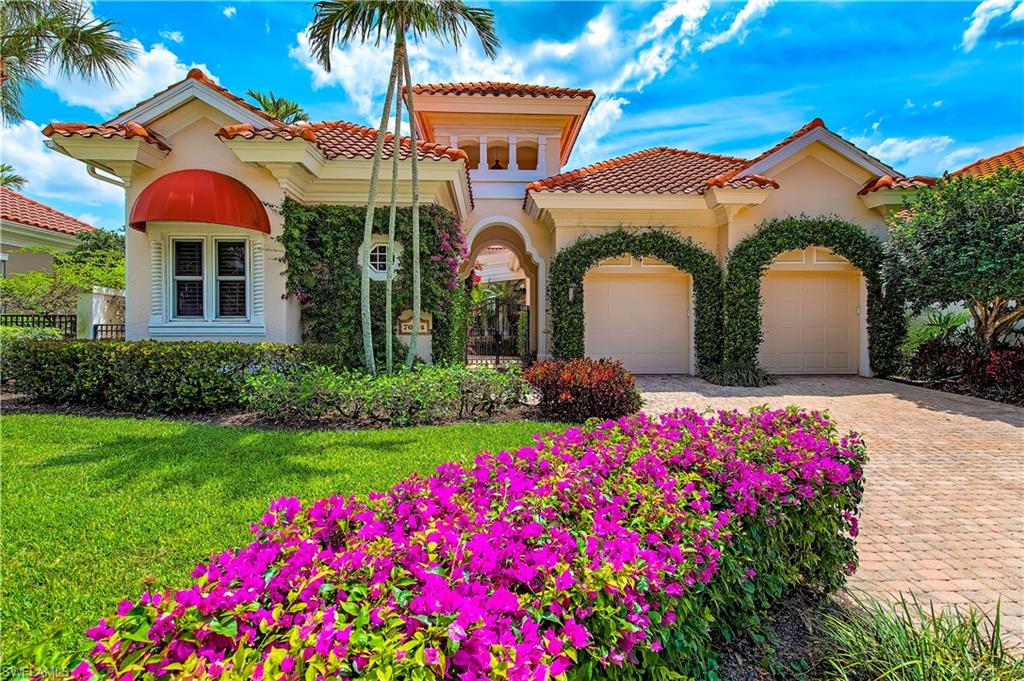 7084 Verde Way Naples, FL 34108 - Photo 2 of 18 a front view of a house with a yard