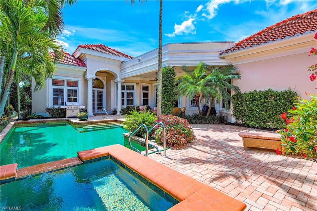 7084 Verde Way Naples, FL 34108 - Photo 4 of 18 a front view of house with yard and outdoor seating