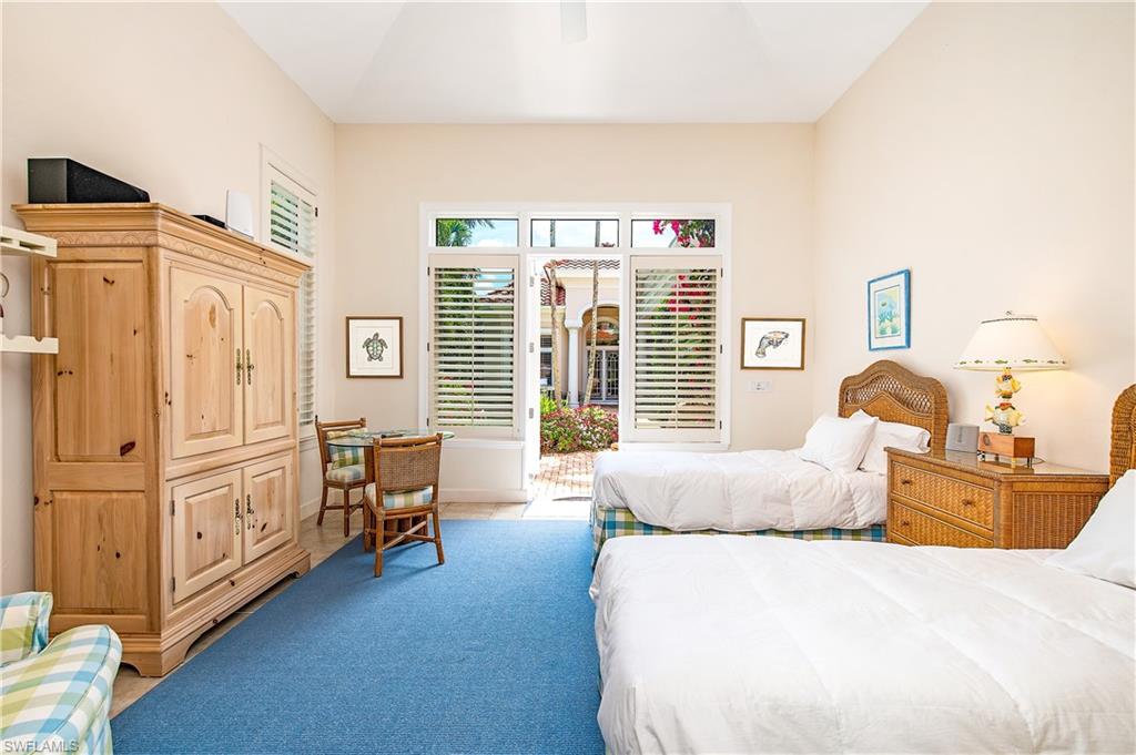 7084 Verde Way Naples, FL 34108 - Photo 7 of 18 a bed room with furniture and a window