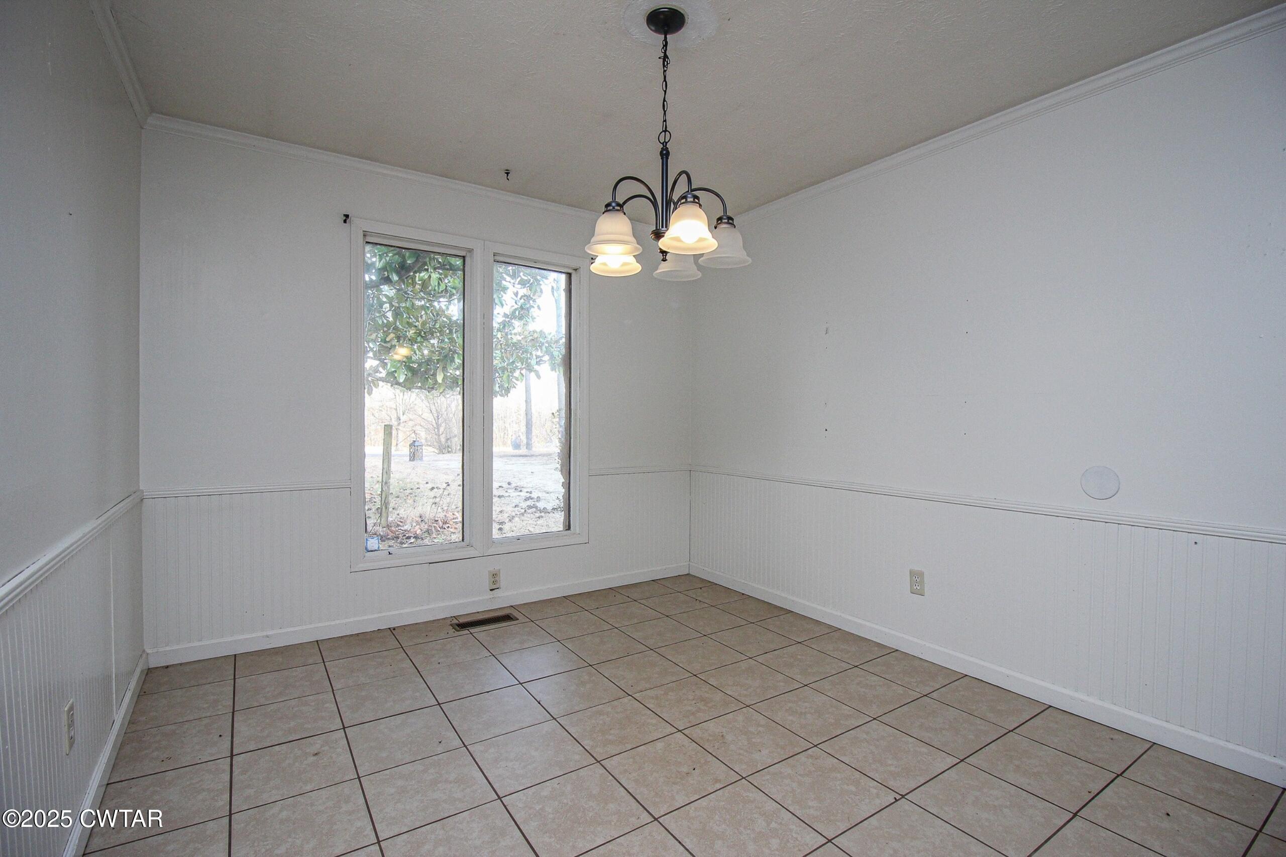 25 Cotton Grove Road Beech Bluff, TN 38313 - Photo 7 of 26 a view of a room with windows and chandelier
