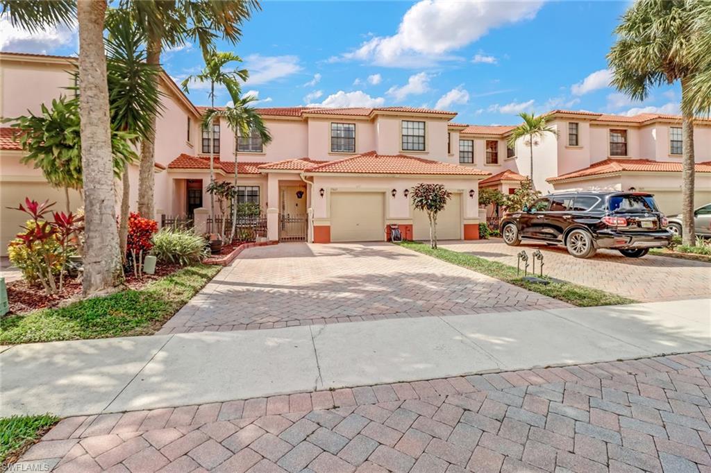 a view of a white house with many windows next to a road
